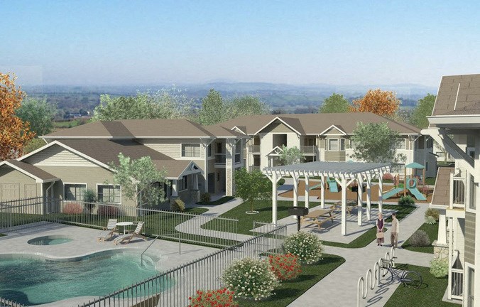 an aerial view of an apartment complex with a swimming pool