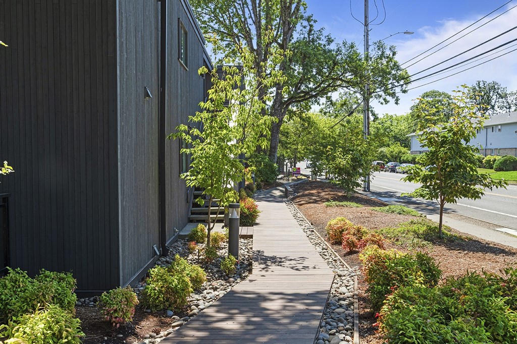 A wooden building with a small garden in front.