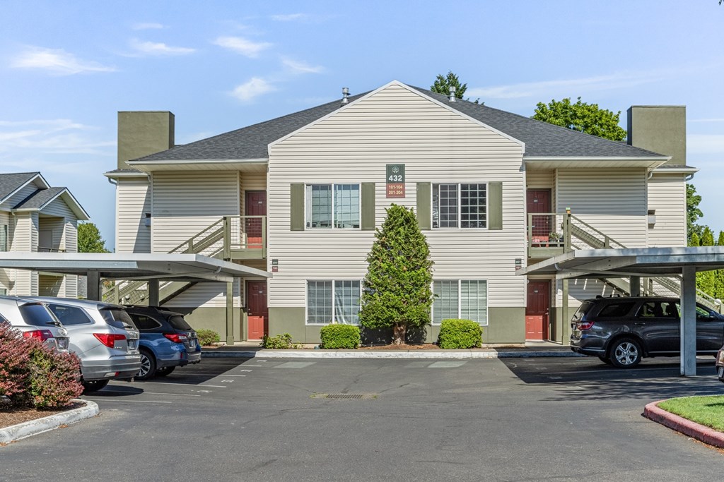 A large two-story building with a parking lot in front.