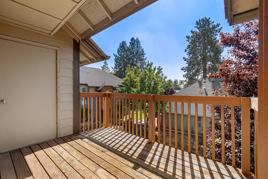 the view from the deck of a home with a wooden railing