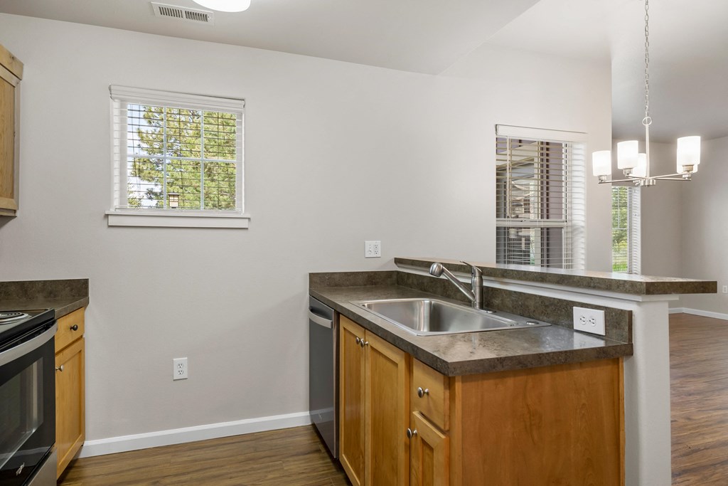 an empty kitchen with a sink and a window