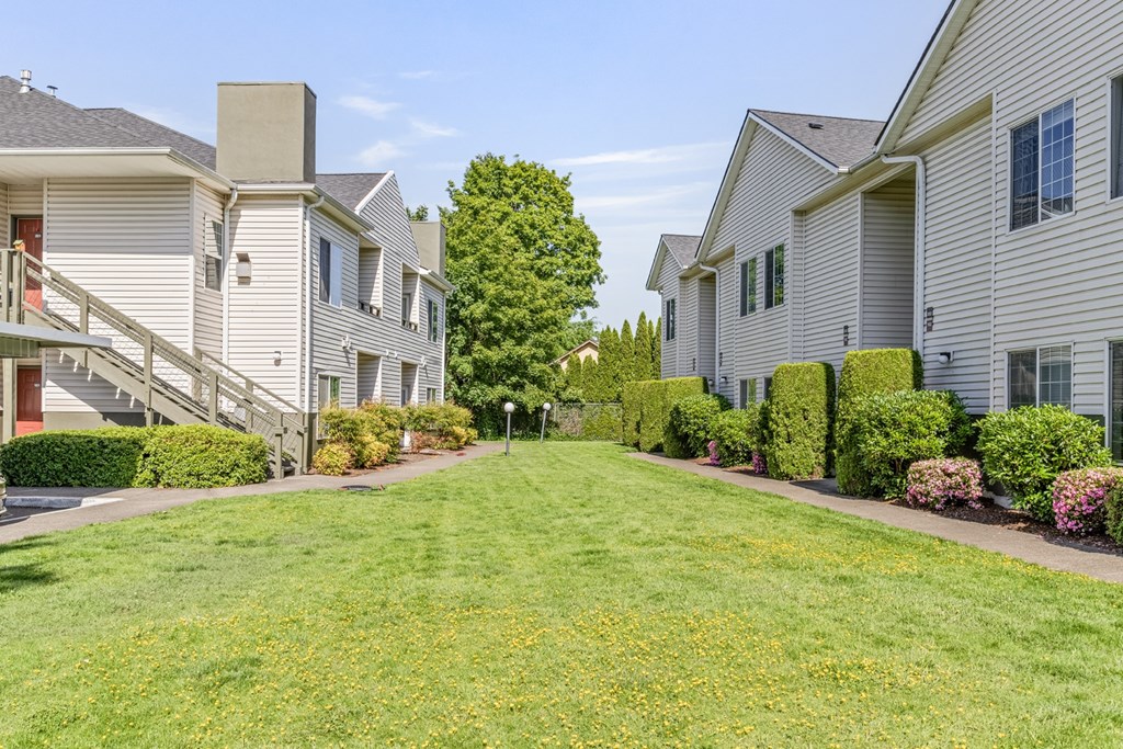 A grassy area in front of apartment buildings.