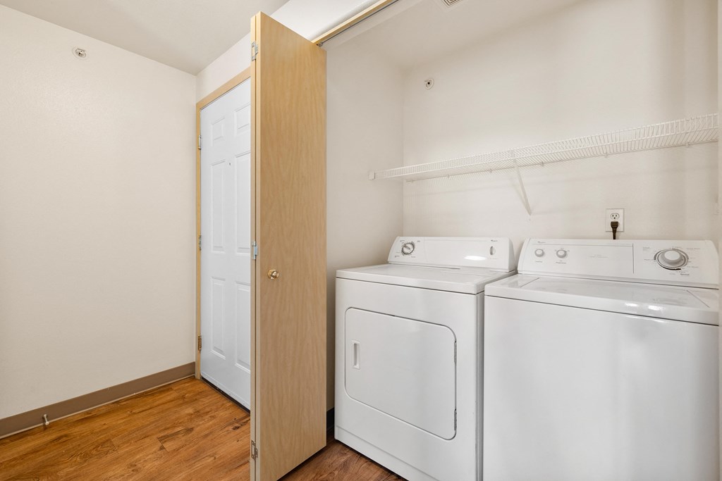 a room with a washer and dryer and a closet with a laundry room