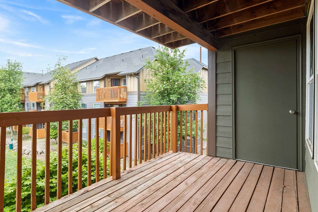 the deck of a home with a door to the backyard