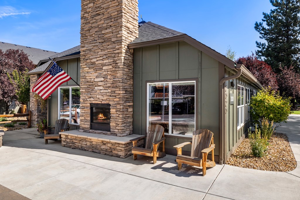 a home with a stone fireplace and an flag on the side