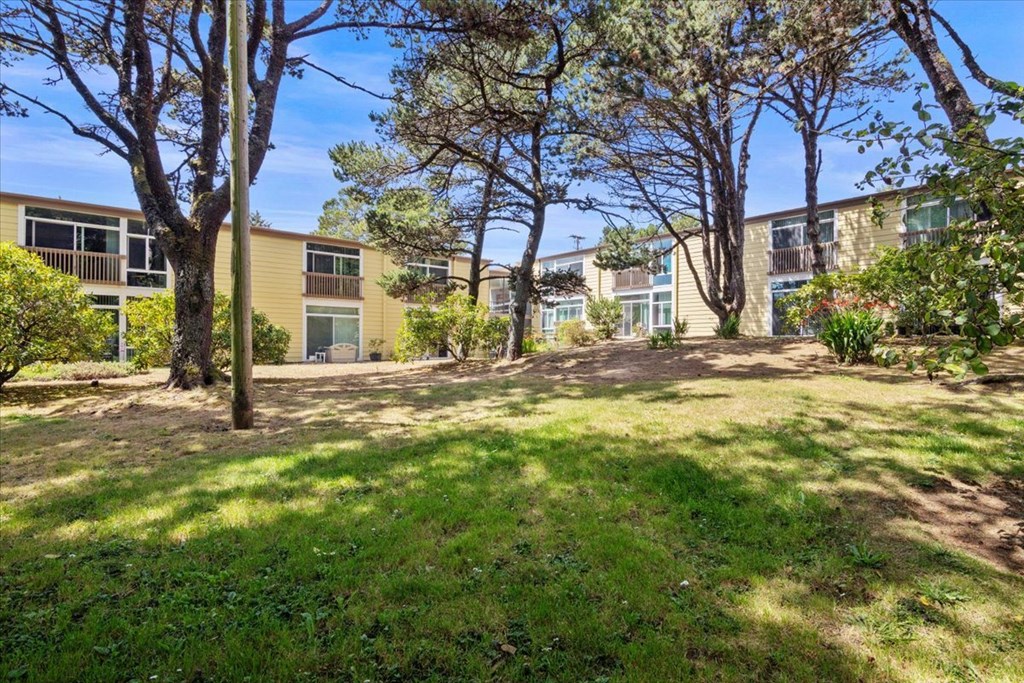 A grassy area in front of apartment buildings.