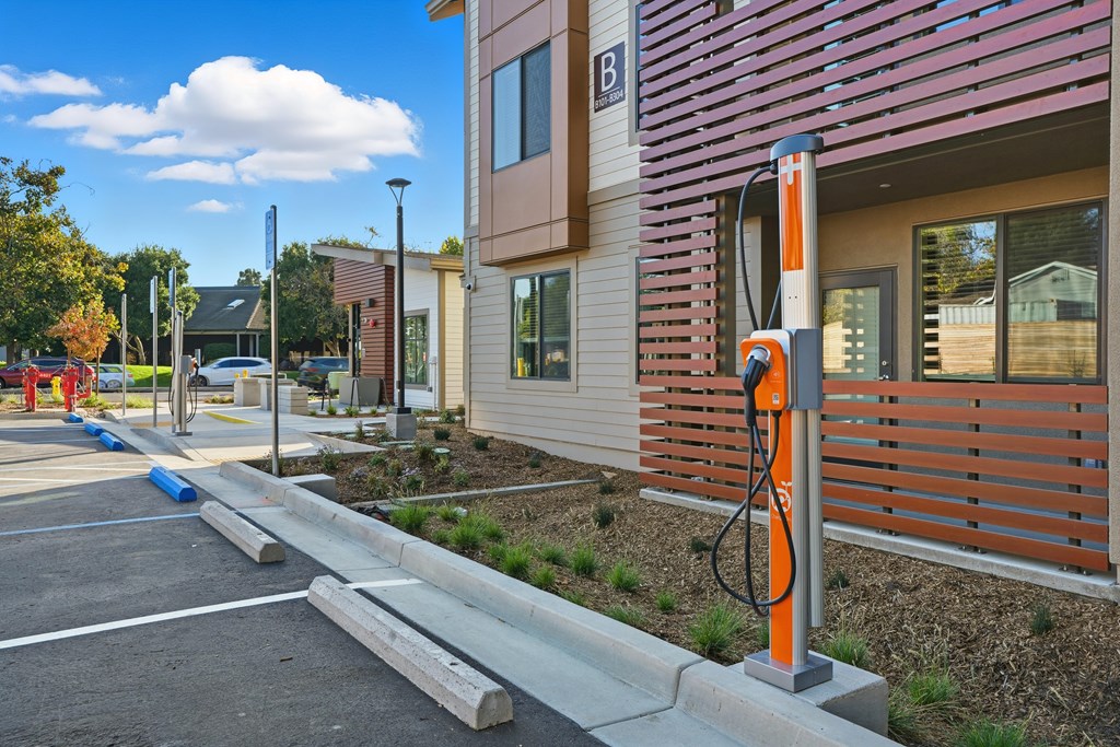 A parking lot with a charging station for electric vehicles.