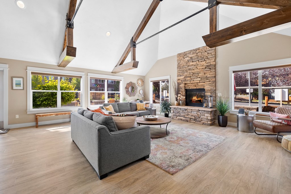 a living room with couches and chairs and a fireplace