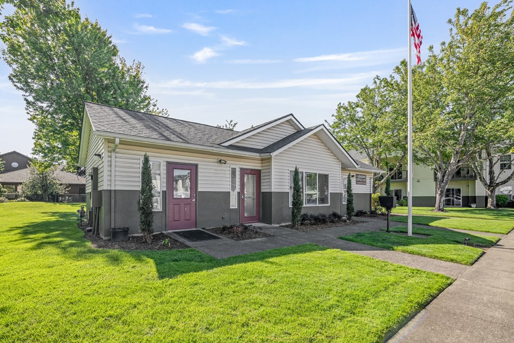 A house with a flag on the lawn.