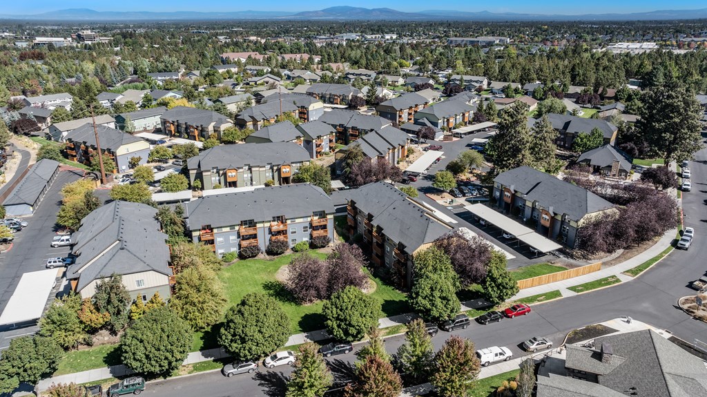 an aerial view of a suburb of houses with cars parked