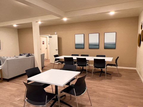 a dining room with tables and chairs and a couch