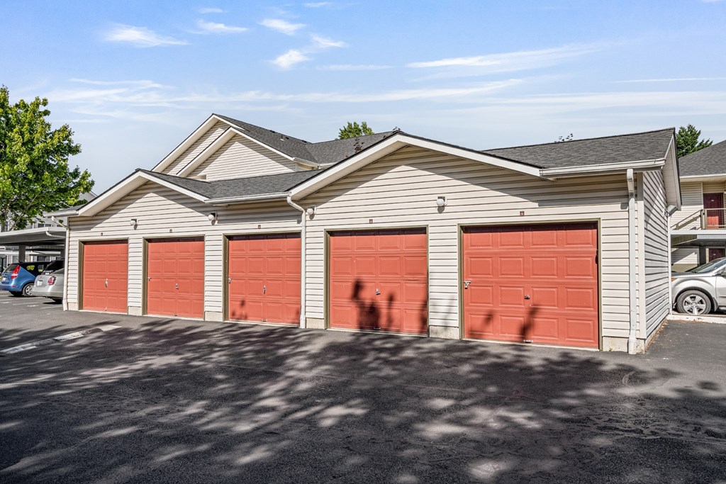 A two-story building with red garage doors.