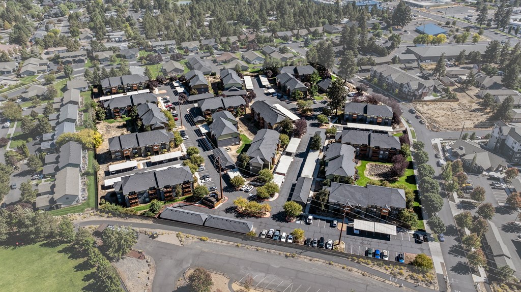 an aerial view of a suburb of a city with houses and cars