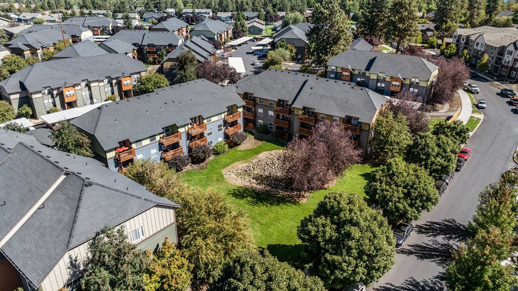 an aerial view of a neighborhood with houses and green grass