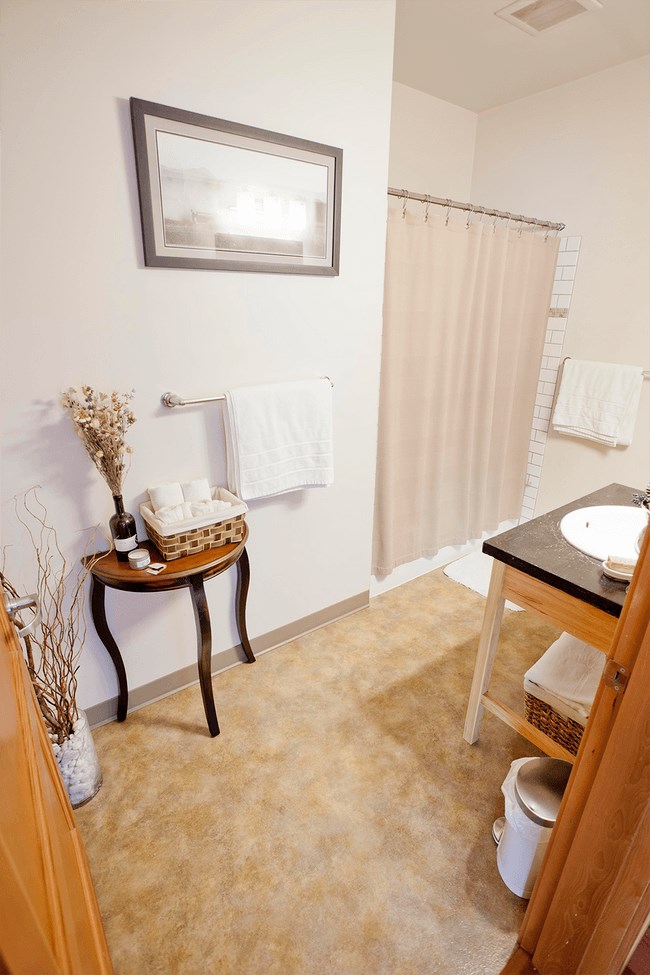 a bathroom with a shower and a sink and a shower curtain