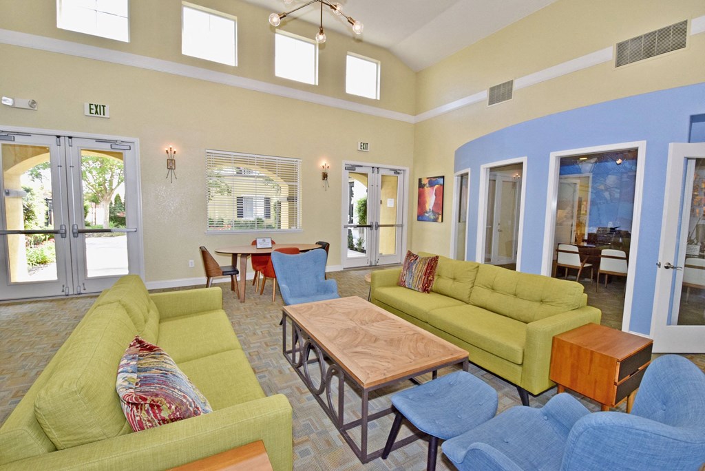 a living room with couches and chairs and a table