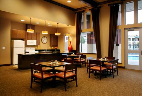 a dining room and kitchen with a table and chairs