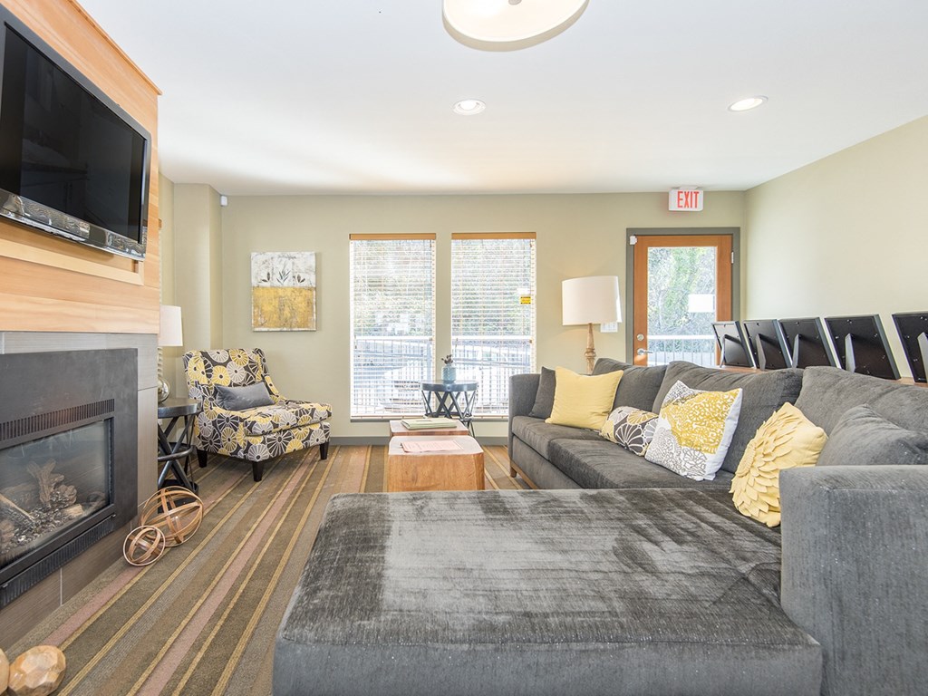 a living room with a couch and a chair and a fireplace