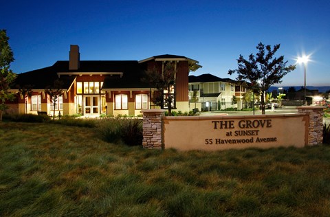 the grove at sunset sign in front of home at night