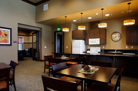 a dining room and kitchen with a table and chairs