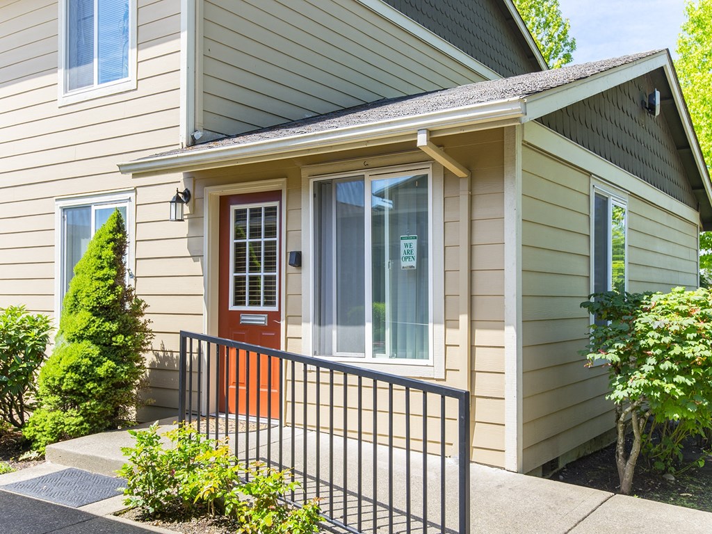 the front entrance to a house with a red door