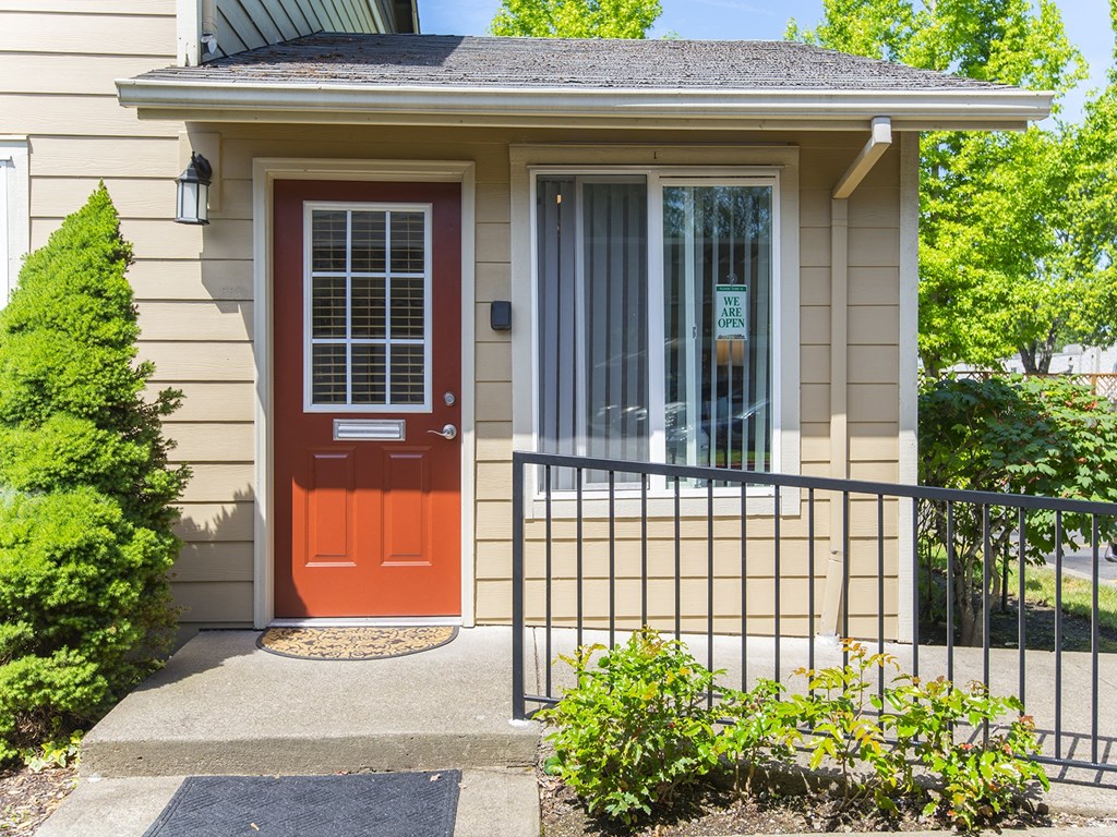 the front of a house with a red door