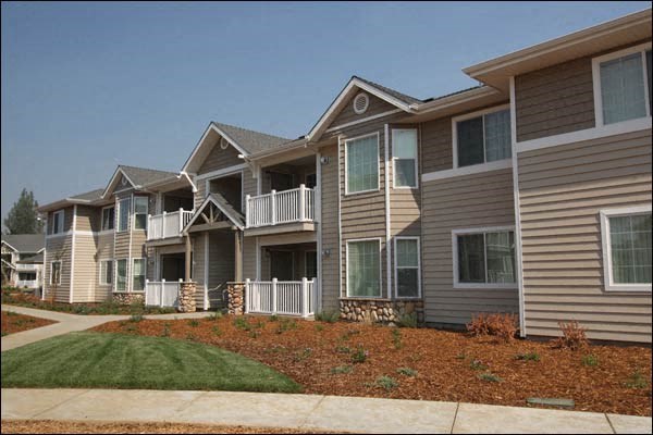 a row of houses with a sidewalk in front of them