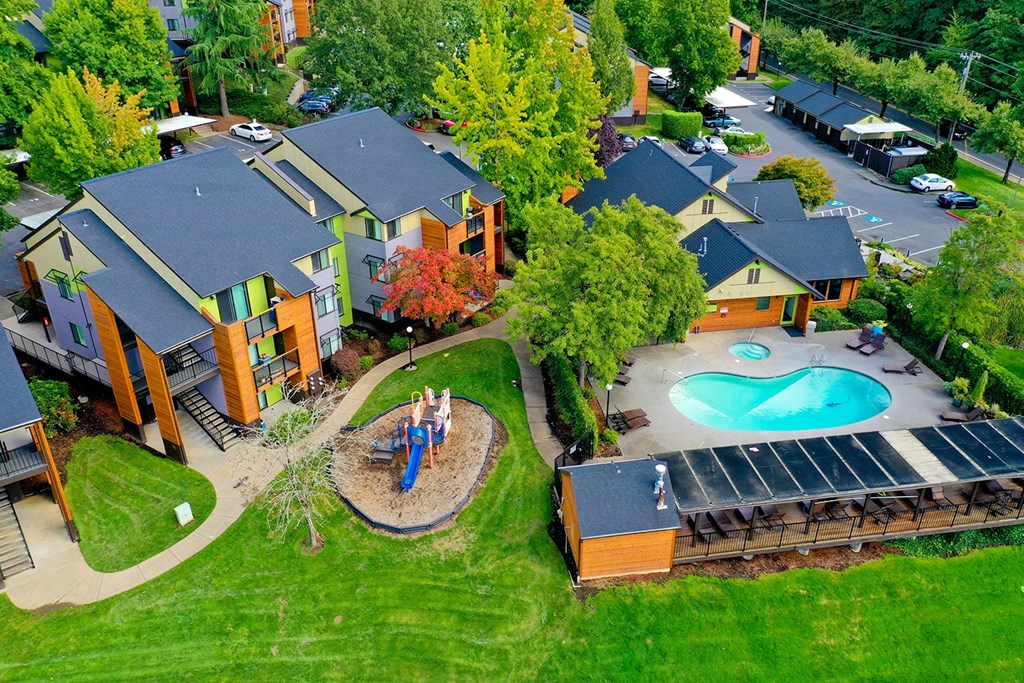 arial view of a backyard with a pool and a house