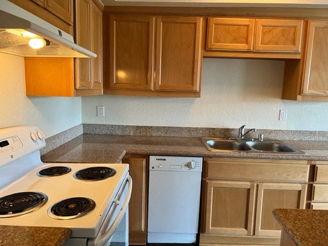 a kitchen with a stove and a sink