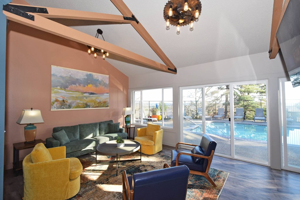 A living room with a yellow chair and a green couch.