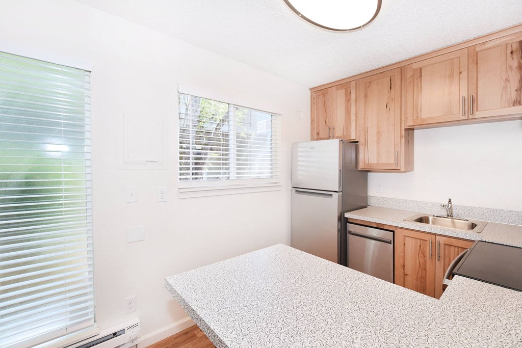 a kitchen with a counter top and a refrigerator