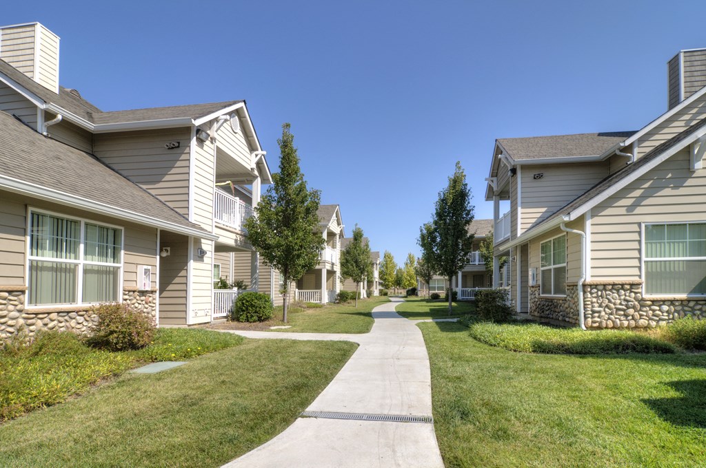 a walkway between two rows of townhomes