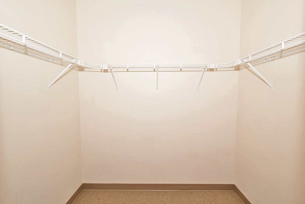a white room with a wire rack on the wall