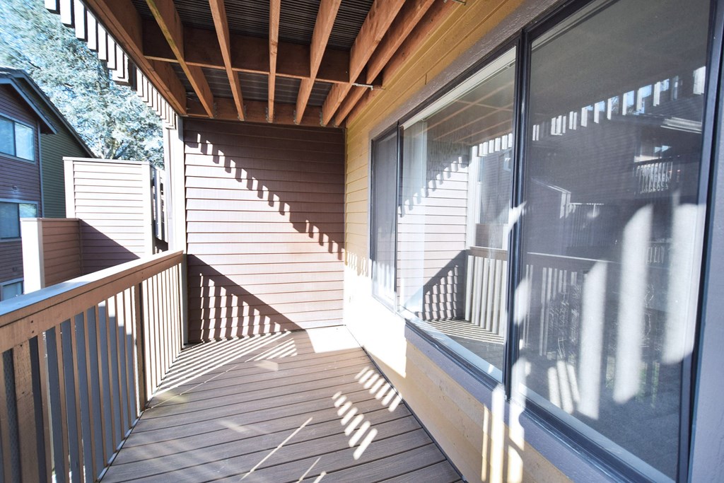 a wrap around deck with stairs leading up to a house