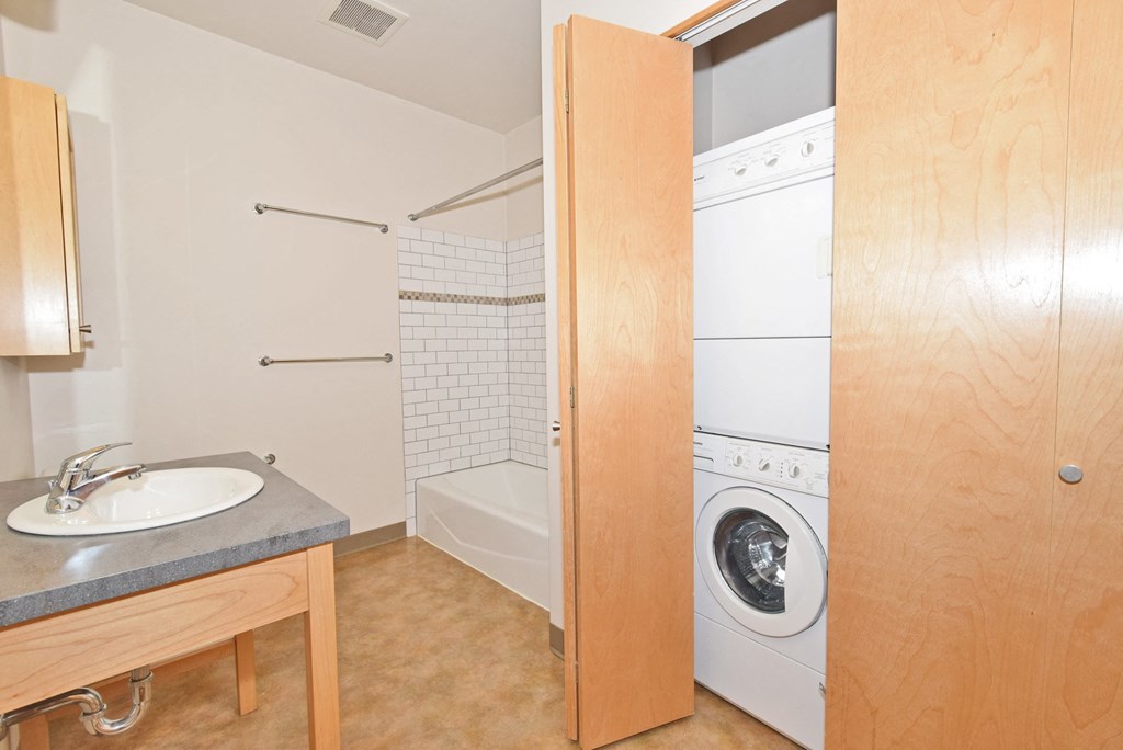 a small bathroom with a washer and dryer in it