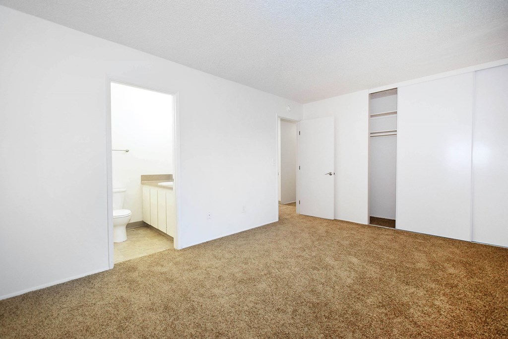 A room with carpeted floor and white walls.