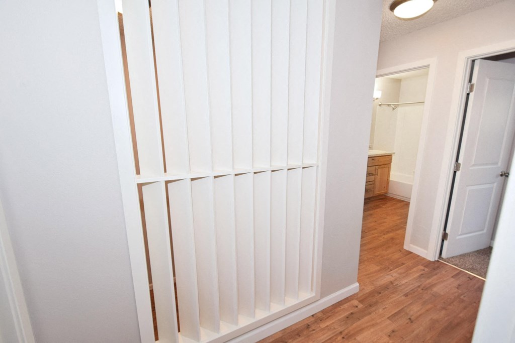 the closet in the bathroom of a home with a white door
