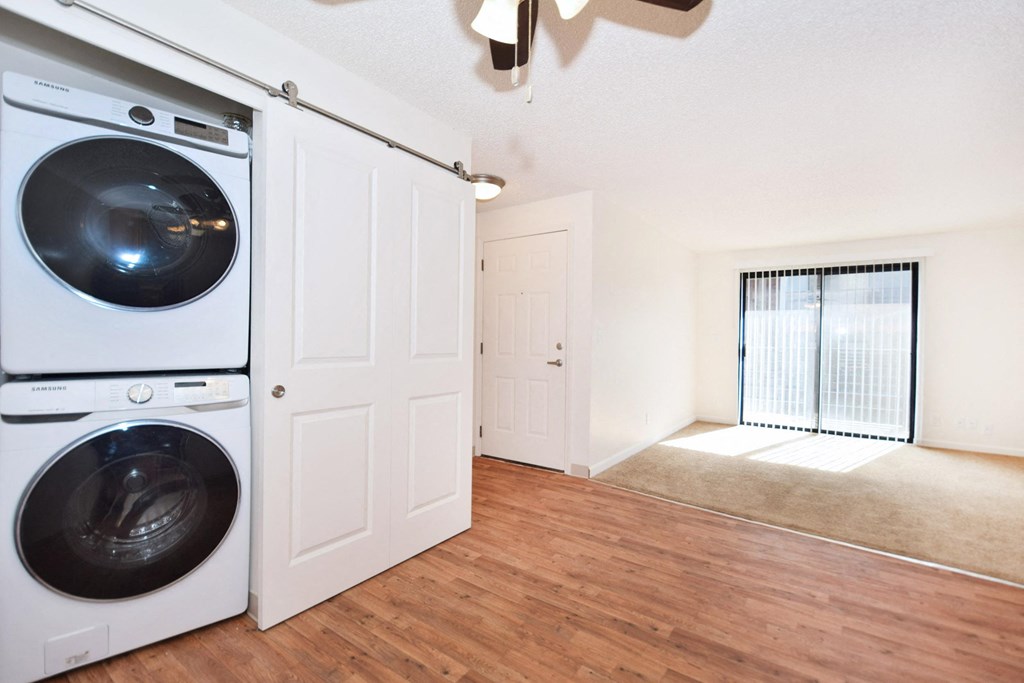 an empty laundry room with a washer and dryer