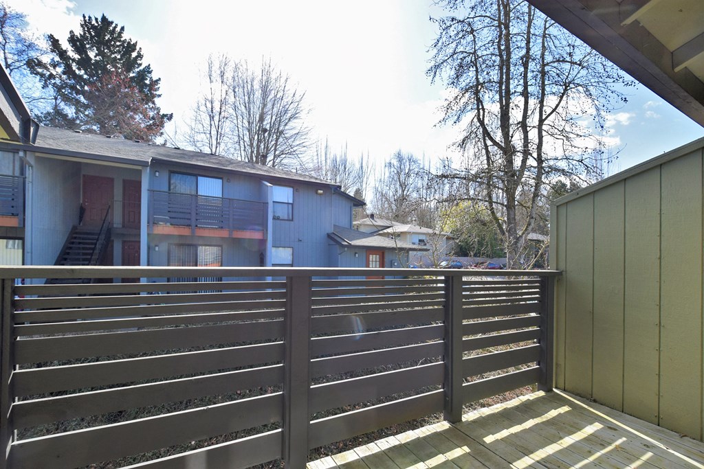 the view from the deck of a house with a wooden fence