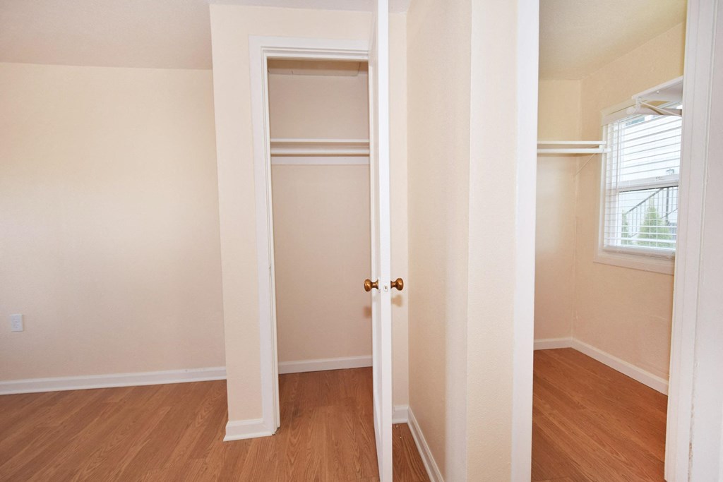 the view of a bedroom with a closet and a window