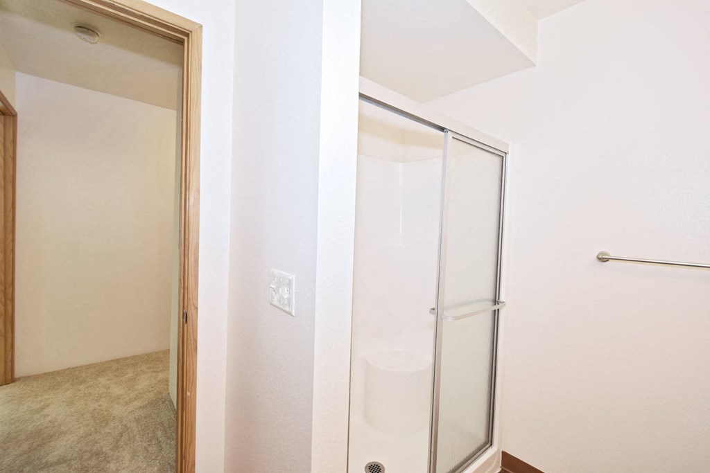 a bedroom with a medium sized bed and a mirror