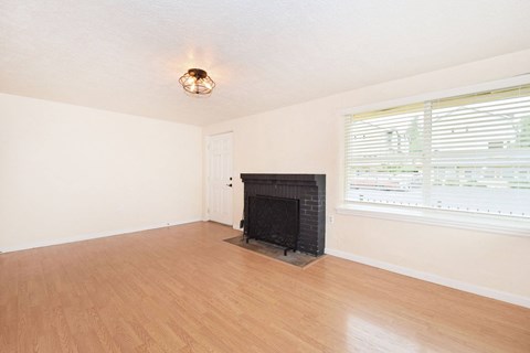 a living room with a fireplace and a wooden floor