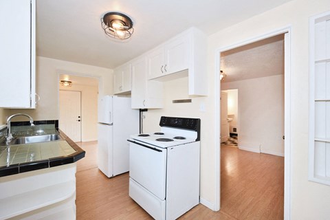 a kitchen with white appliances and white cabinets