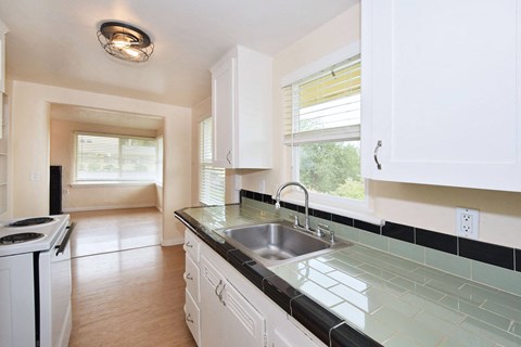 an empty kitchen with a sink and a window