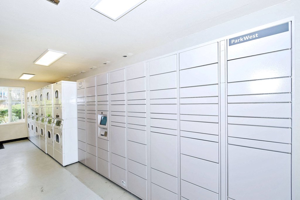 the laundry room has a long wall of washers and dryers