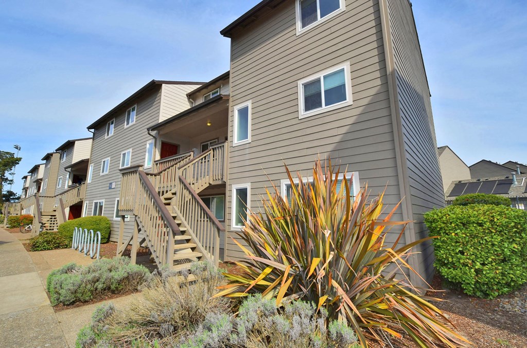 a row of town homes with stairs and balconies