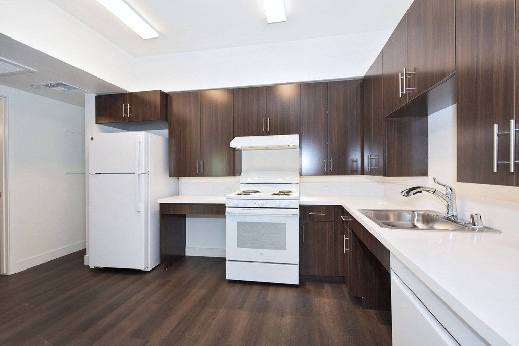 a kitchen with white appliances and wooden cabinets