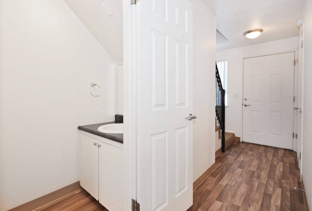 a bathroom with a sink and a door to a hallway