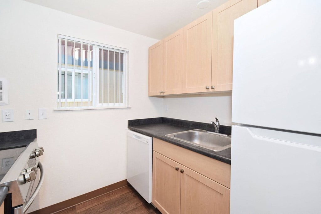 a kitchen with a sink and a refrigerator