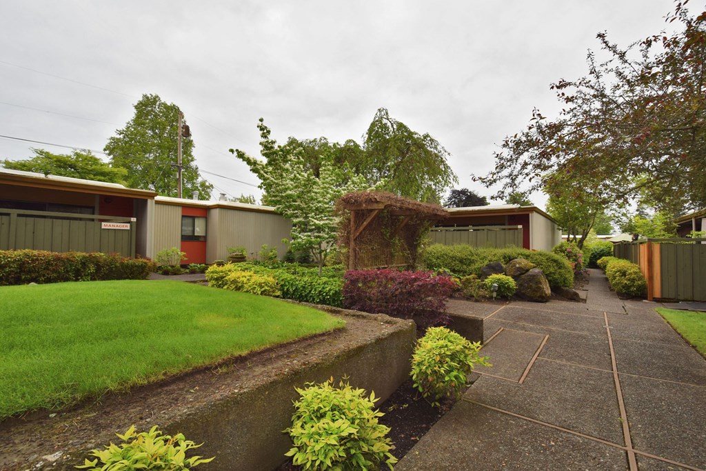 the front of a house with a garden and a walkway